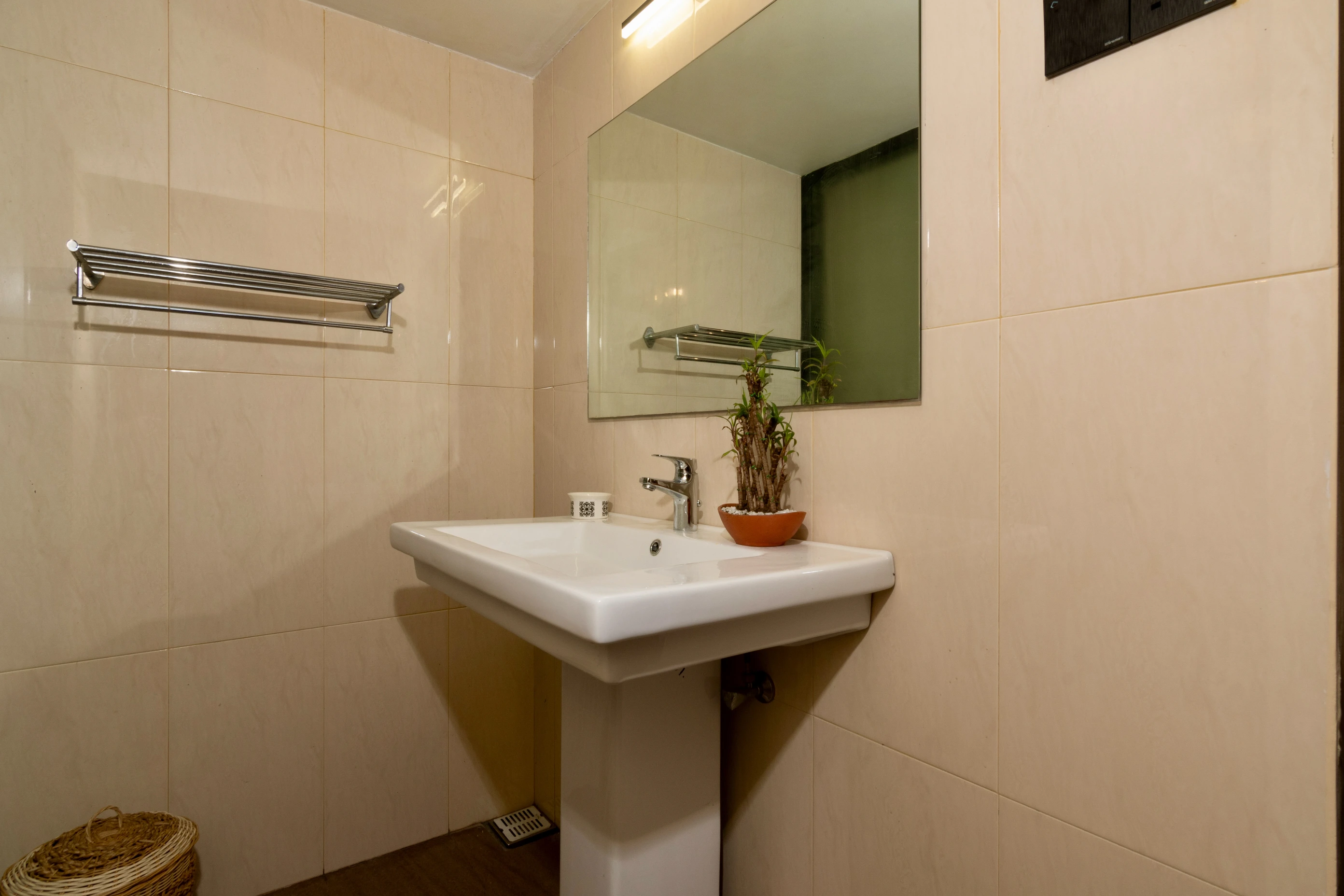 Beige walls of the bathroom and white sink