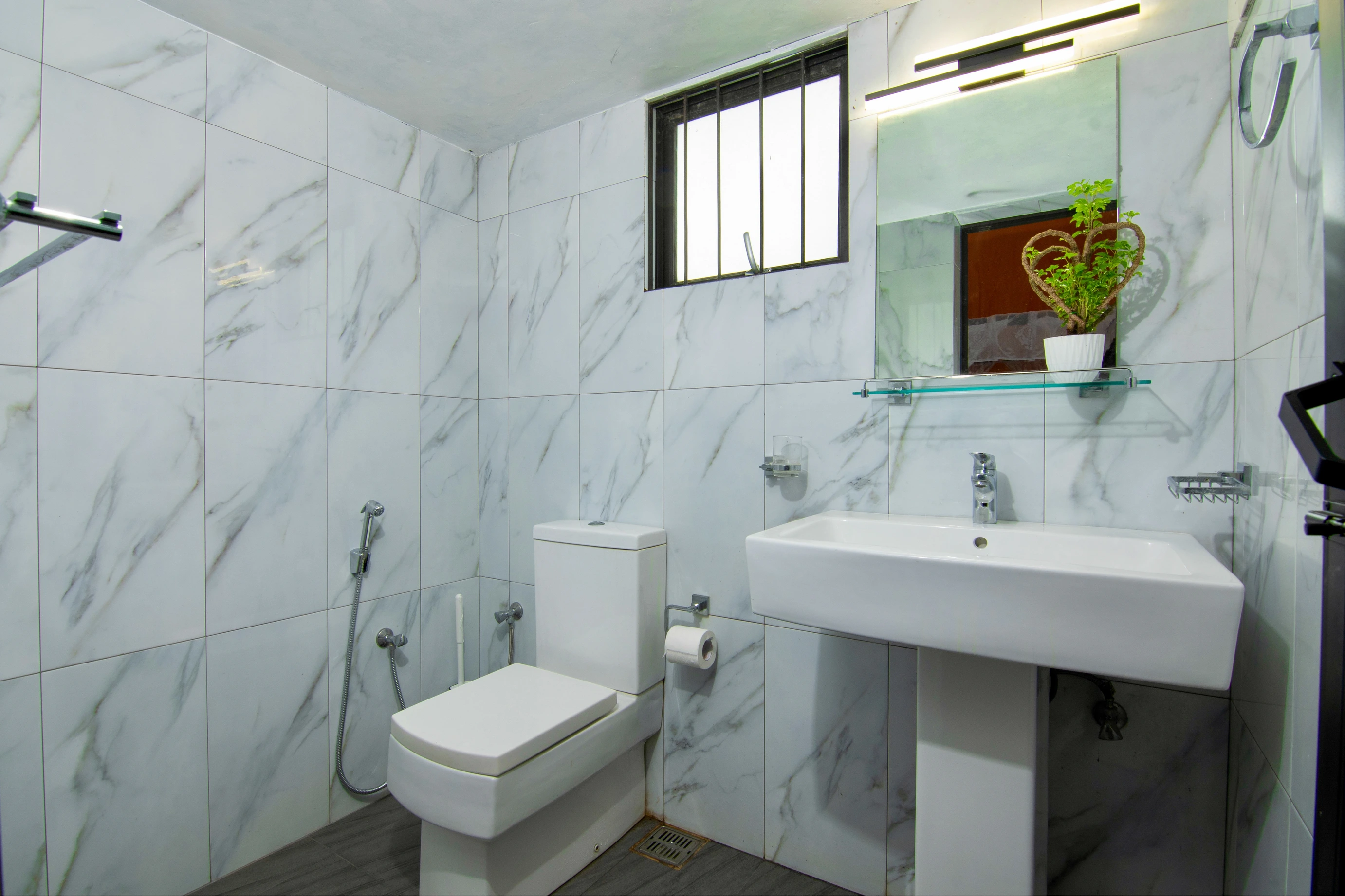 While bathroom with closet and sink