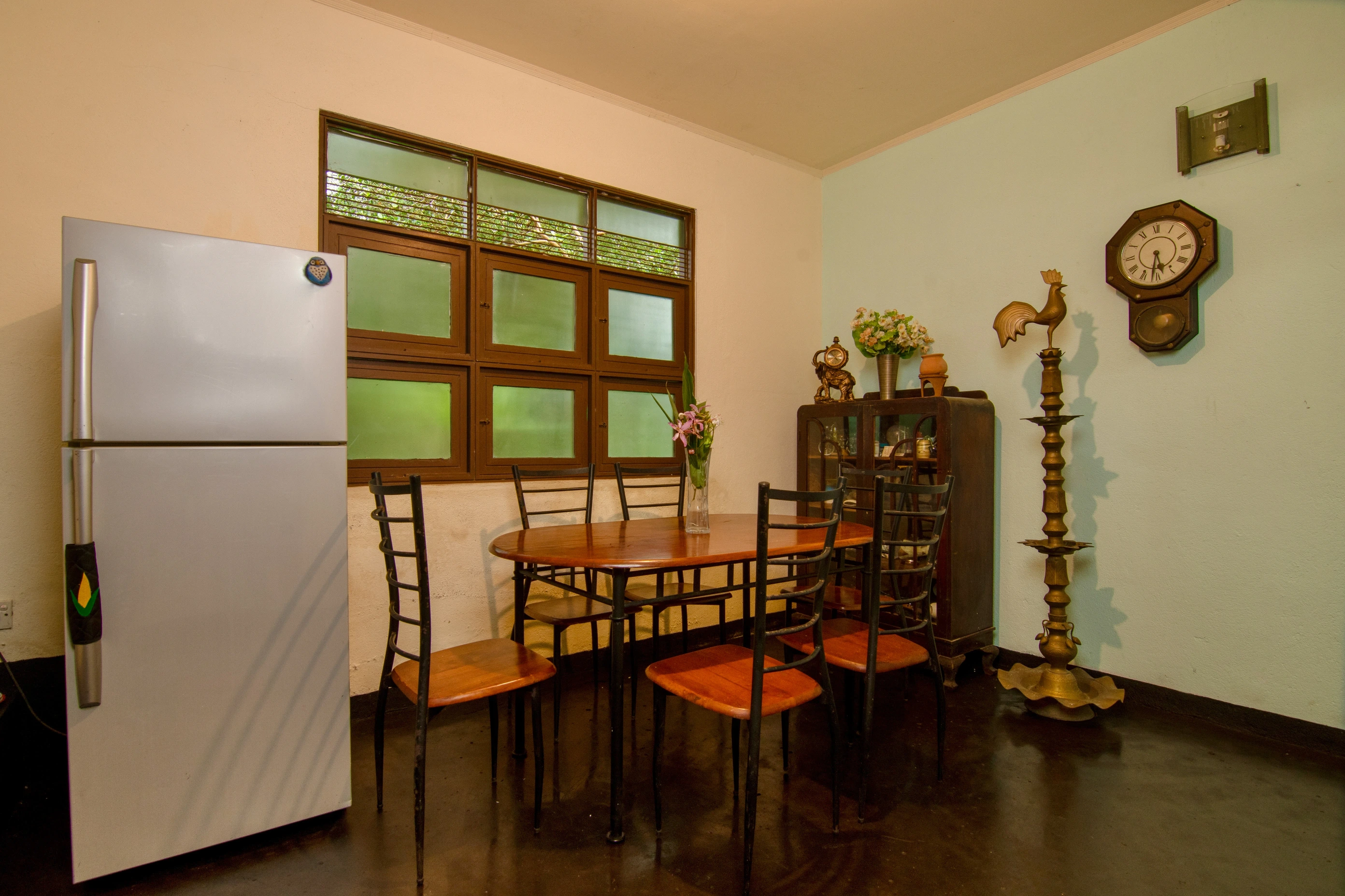 Kitchen with table, chairs, fridge and other furniture