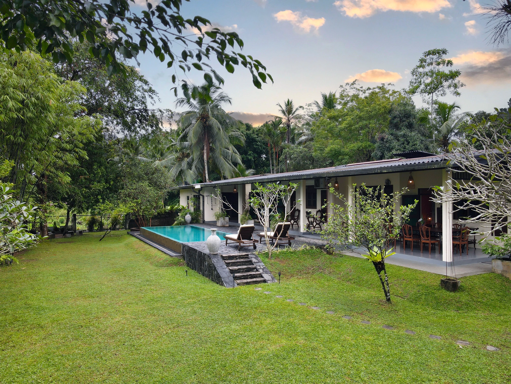 Villa, swimming pool and green lawn from further away