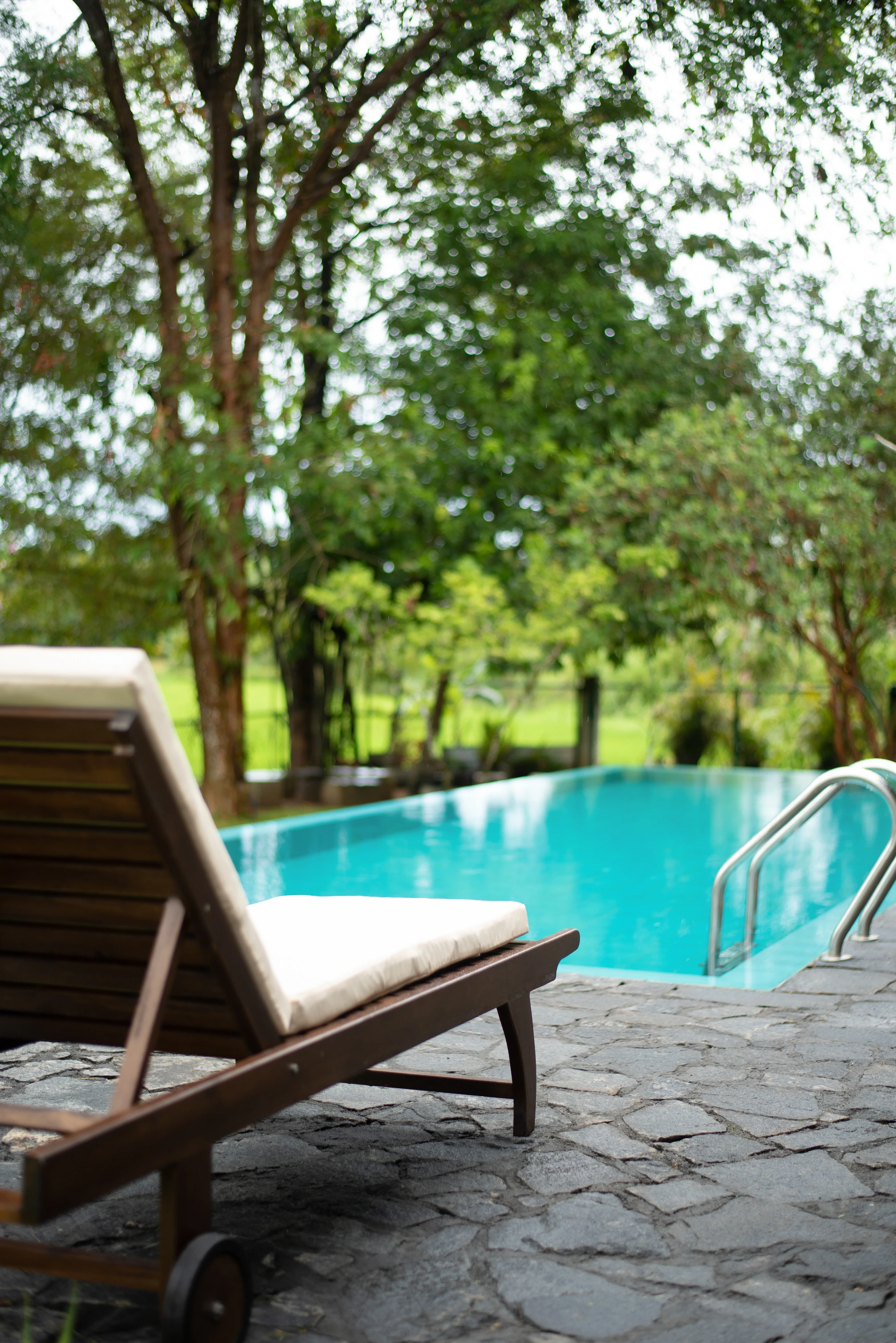 Swimming pool and white sunbed